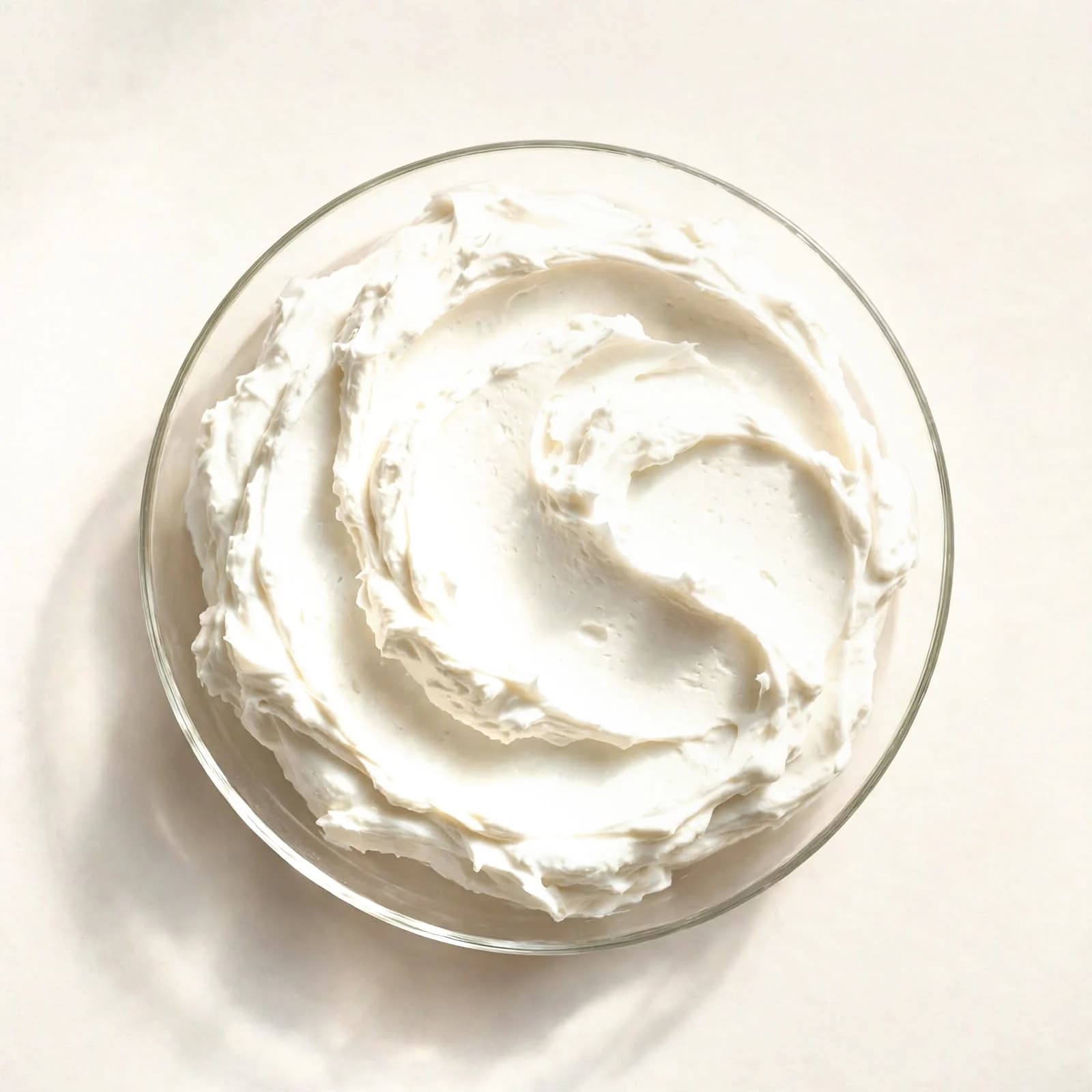 Thick coconut cream spread in a glass dish, seen from above.
