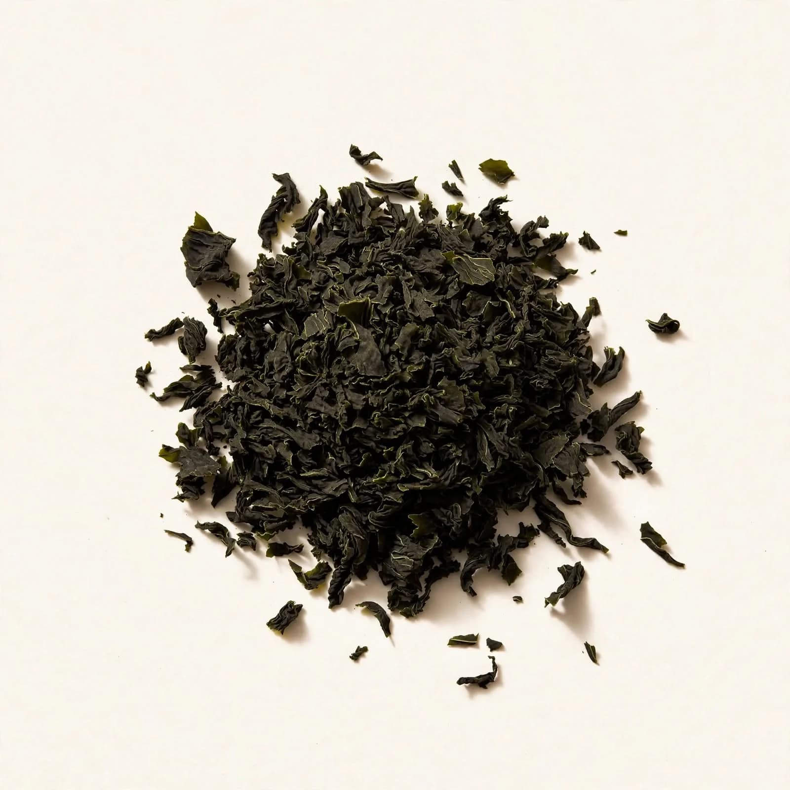 A heap of dark green dried cut wakame, seen from above.
