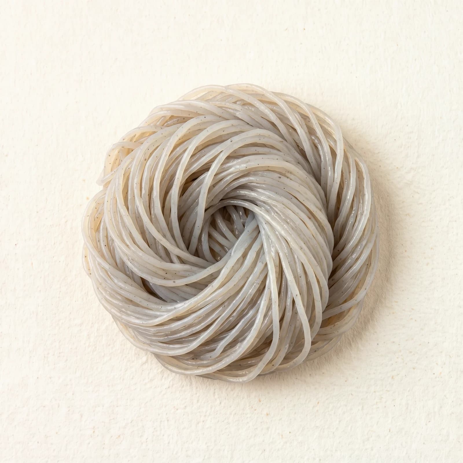 Konjac noodles, translucent and packed in water, showing the smooth surface and the even thickness.